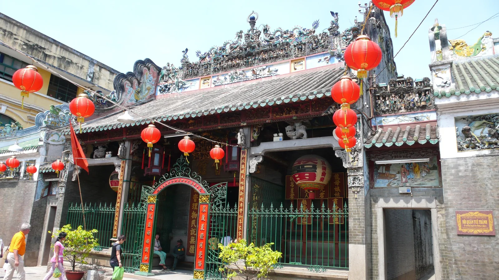 Red lanterns decorate the ornate roof and gates of Tue Thanh Assembly Hall temple in Saigon