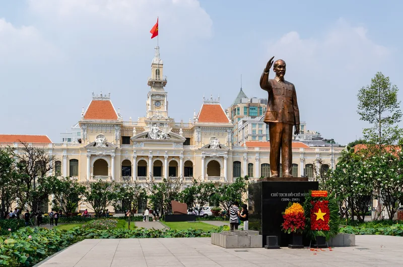 A bronze statue of Ho Chi Minh stands before the colonial-era City Hall in Ho Chi Minh City.