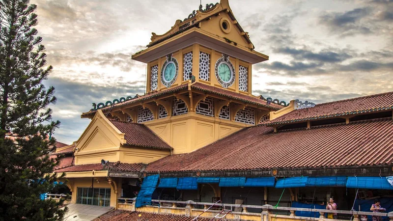 The clock tower of Binh Tay Market rises above tiled rooftops in Ho Chi Minh City's Cho Lon district.
