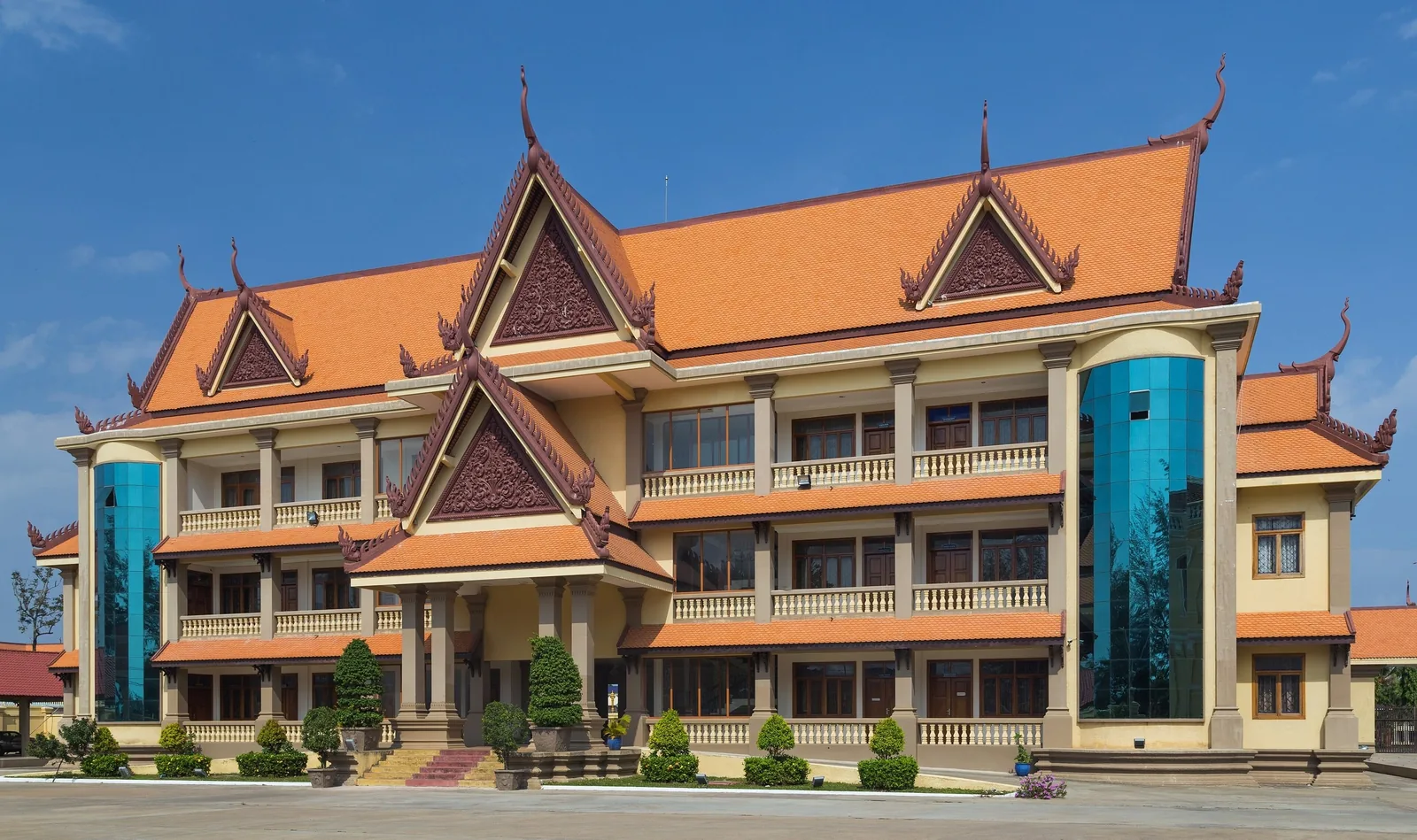 Orange-roofed provincial building with Khmer-style pediments in Kampot, Cambodia.