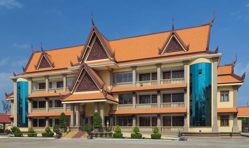 Orange-roofed provincial building with Khmer-style pediments in Kampot, Cambodia.