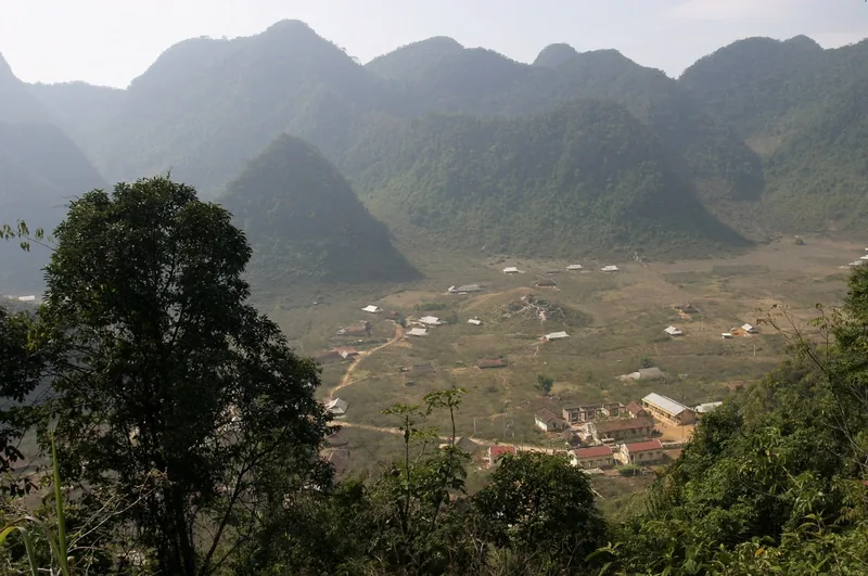 A small village nestled in a valley surrounded by limestone peaks near Mai Chau, Vietnam.