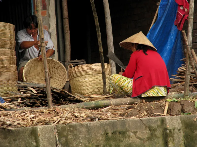 Villagers weave bamboo baskets by hand at a workshop in the Mekong Delta.