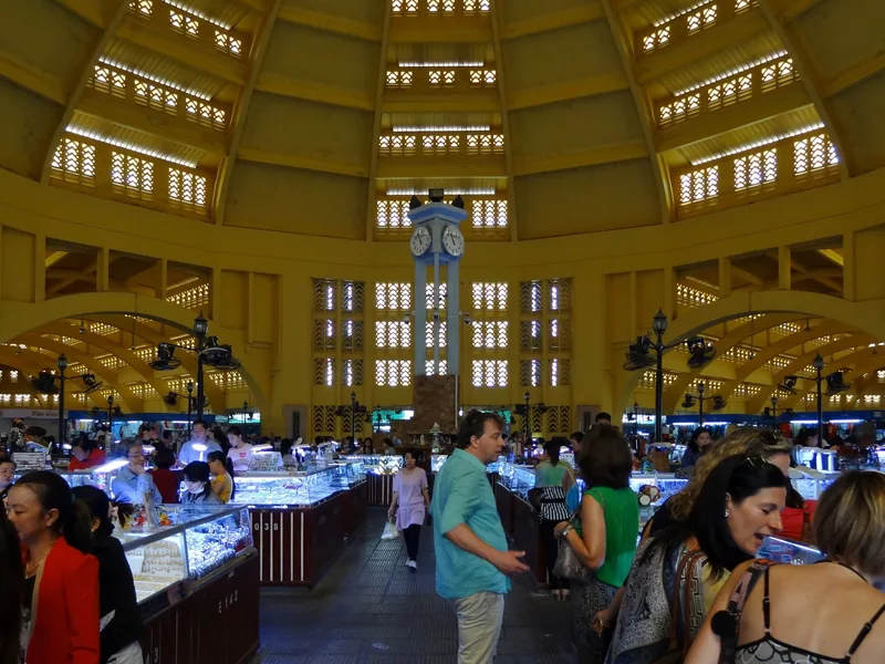 Shoppers browse jewelry stalls beneath the domed art deco ceiling of Phnom Penh's Central Market.