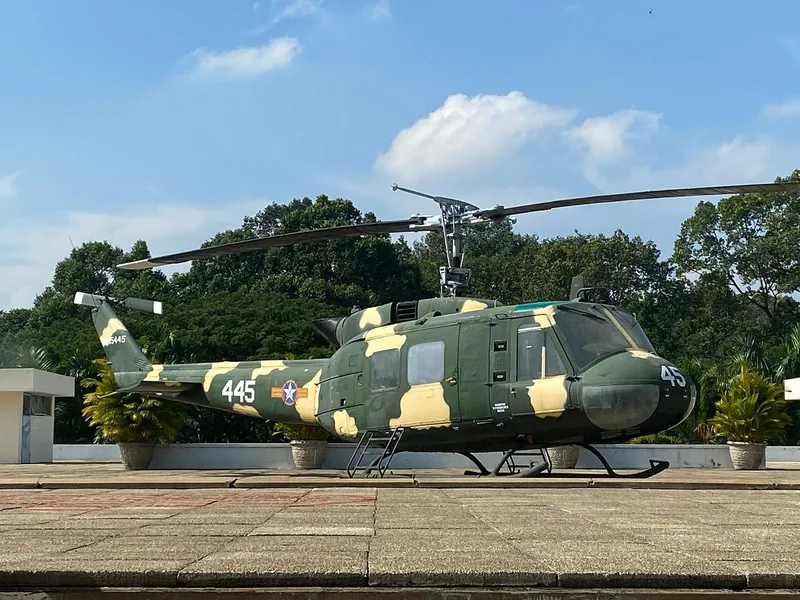 A camouflaged UH-1 helicopter displayed on the rooftop of the Independence Palace in Saigon.