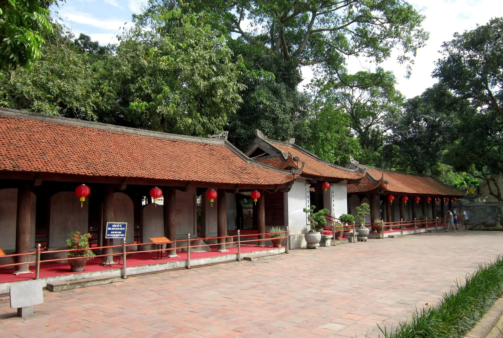 Traditional tiled-roof pavilion with red lanterns and wooden columns at a Vietnamese temple complex, likely the Temple of.