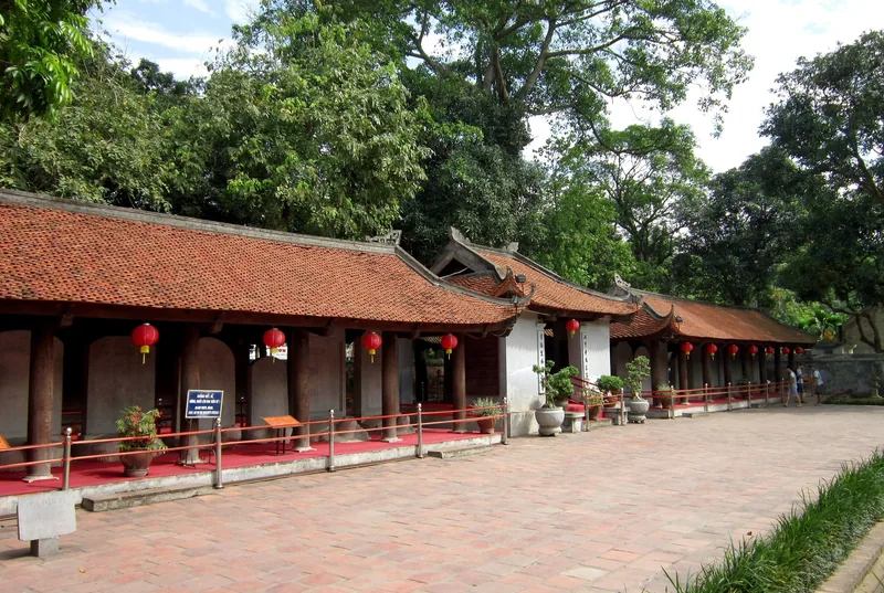 Traditional tiled-roof pavilion with red lanterns and wooden columns at a Vietnamese temple complex, likely the Temple of.