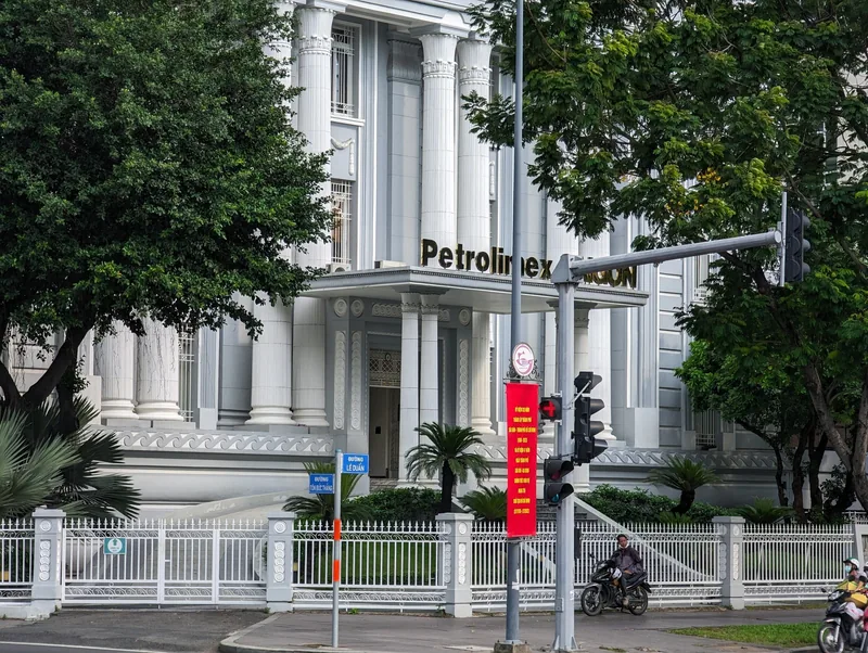 A colonial-style building with tall columns houses the Petrolimex Saigon office in Ho Chi Minh City.