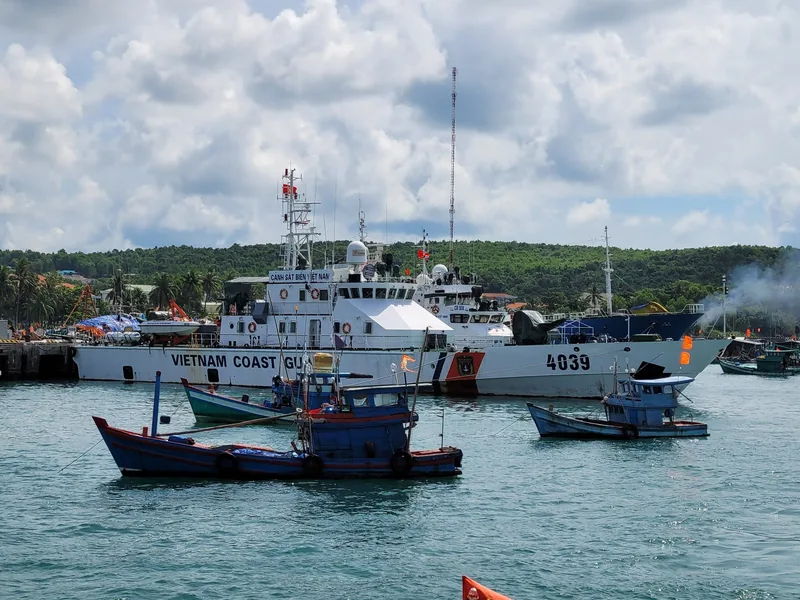 A Vietnam Coast Guard patrol vessel and small fishing boats anchor in the harbor at Phu Quoc.