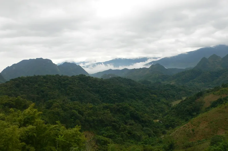 Forested mountain ridges and low clouds stretch across the valley at Pu Luong Nature Reserve.